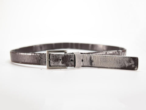 a genuine leather belt so worn that is reveals its made with a thin layer of leather over scraps and glue