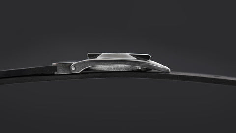 dramatic profile shot of the side of the Series 7 Dial buckle against a black background highlights the new tapered curves of the buckle.