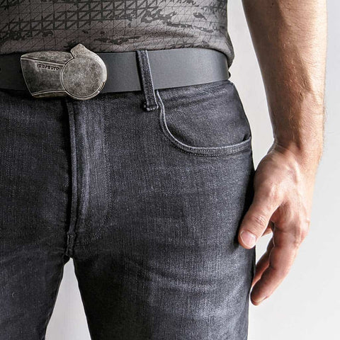 distressed metal belt buckle with black leather belt on dark jeans and a t-shirt