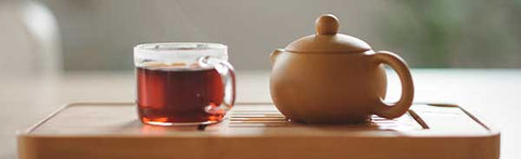 small teapot and cup of the best black tea