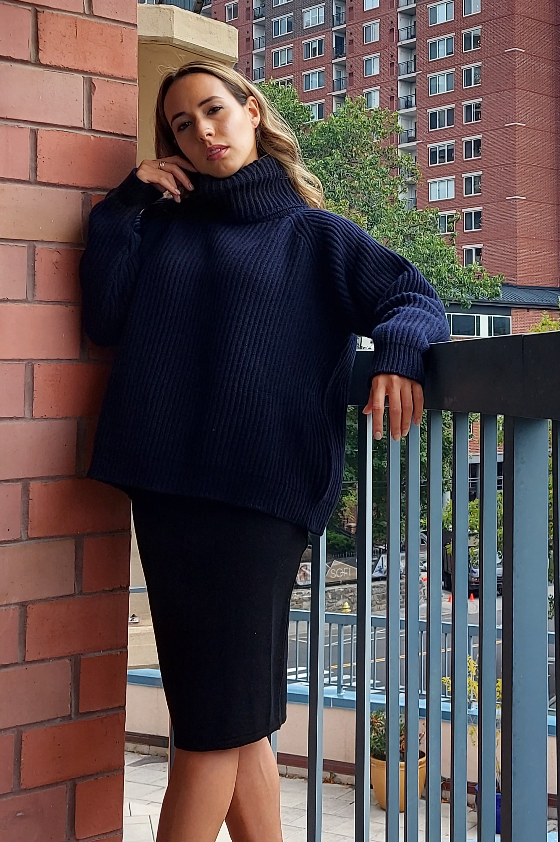 Della Wool Roll Neck Ribbed Sweater in Navy Blue with a cropped silhouette and fold-down collar. 
