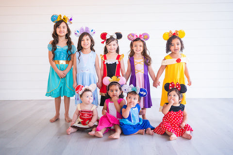Group of girls wearing different princess dresses