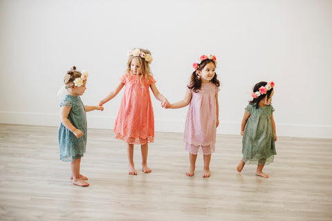 Group of girls wearing lace dresses and flower crowns