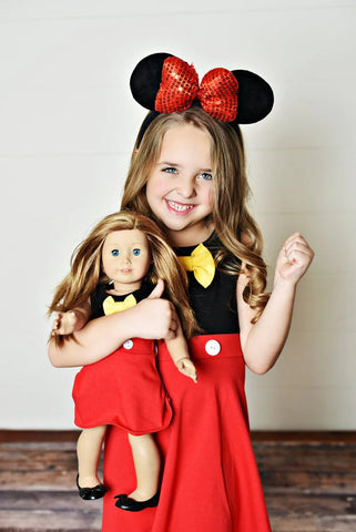 Little girl and her doll wearing matching boy mouse dresses