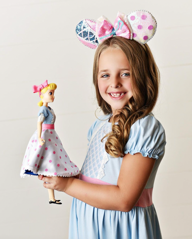 Little girl matching her Little Bo Peep doll