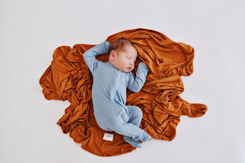 Baby lying on a swaddle blanket