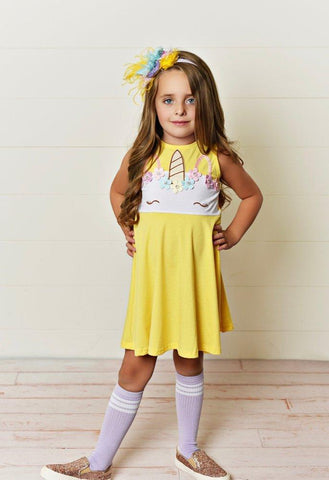 Girl in yellow unicorn dress