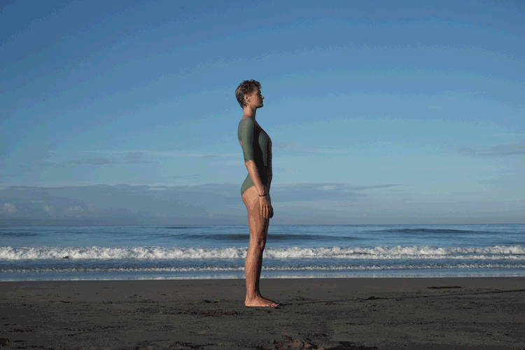 Forward bend with arms over yoga warm up for surfes Uttanasana