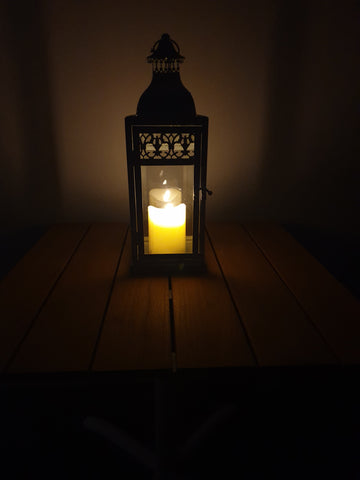 battery operated candle in lantern on coffee table
