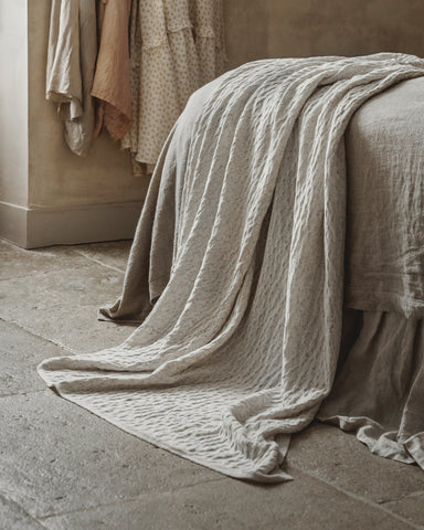 Textures from different textiles combined in the bedroom. Styled and photographed by Anna Malmberg.