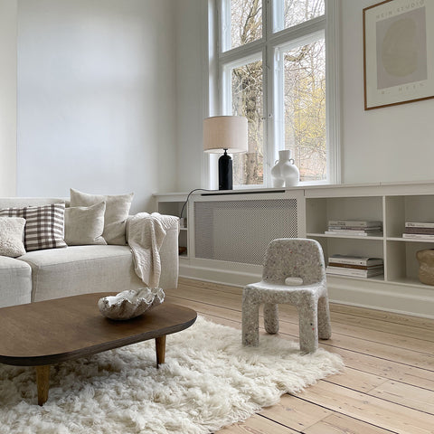 A cosy living room with Charlie Chair Off-White and Coral Blanket. Styled and photographed by Simone Wiuf Larsen.