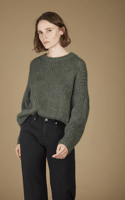 This Khaki Knitted Jumper has Oversized Balloon Sleeves and is a Statement Colour for Autumn/Winter that works well with Black and Neutral Tones.  With a Beautiful, Fluffy Feel, a Ribbed Neckline & Cuffs.  A Blend of Wool & Mohair make this Knit Extra warm and Cosy to get you through these Chilly Winter months.  Tuck this Jumper into High Waist Jeans/Pants or Layer it over a Skirt.