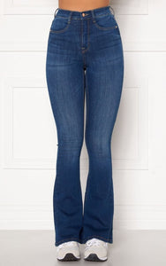 This is an image of the Tove High Waist Flared Super-stretch Jeans Medium Blue Denim. Introducing a new fit for Spring/Summer, The Tove Jeans are High Waisted and Flare at the bottom.  They have a Skinny Fit from the Waist Down to the Knee and are still Super Flattering on the thighs and Bum area.  They are Super Stretchy making them Comfortable to wear and are ideal for giving your legs a longer more slim look.  Since the jeans are super stretchy, they look smaller than they are. Select your regular size, 
