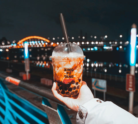 Hand holding Xin Fu Tang boba cup