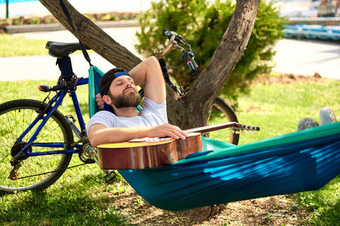 a man lying down in a hammock