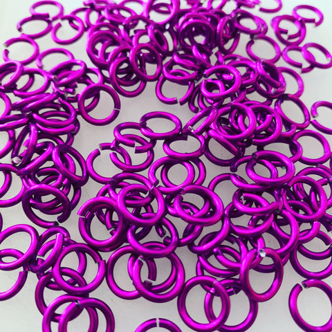 Large pile of violet colored jump rings