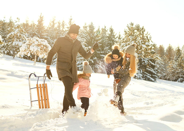 Happy family playing in snow