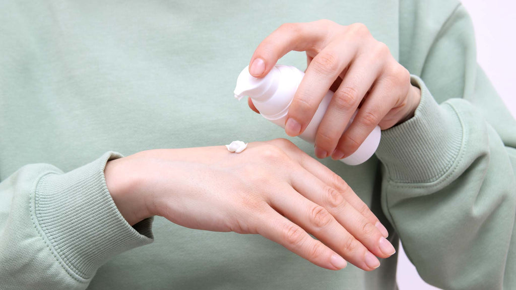 Woman applying lotion to her hands