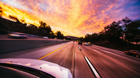 Car on road at sunset