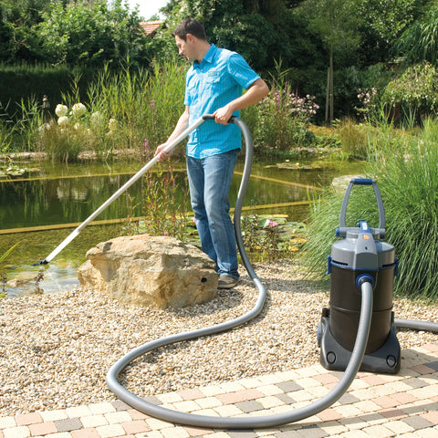 Man using the Oase PondoVac to Clean Pond
