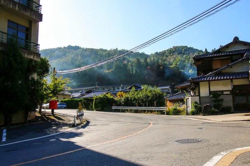 Some traditional houses billowing out smoke from the chimney we pass on the climb up the 162.