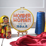 Wonder Woman hear me roar cross stitch kit framed in a hoop with threads and fabric
