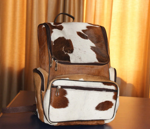 Discover the perfect blend of style and uniqueness with our cowhide backpack - be bold, be different, and turn heads wherever you go.