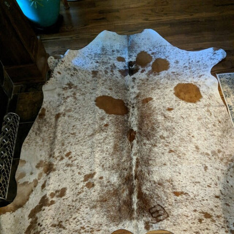 Each unique panel in this cowhide rug tells a story, blending seamlessly to create a captivating visual symphony. No two rugs are alike, making yours truly one-of-a-kind.