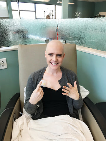 Kelsey Bucci sitting with chemo port 
