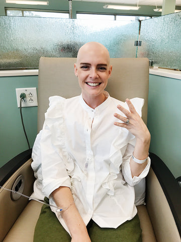Kelsey Bucci sitting wearing fashionable blouse at chemo appointment