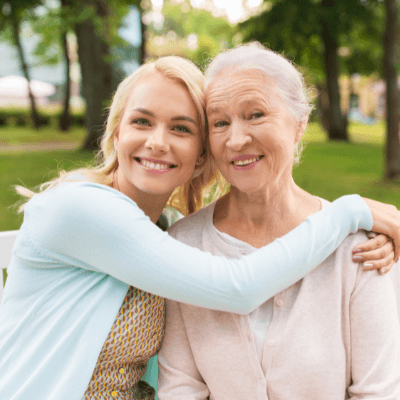 woman hugging elderly relative fighting cancer