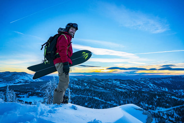 Snowboarder with board in hand