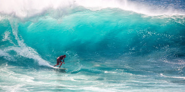 Surfer riding a huge ocean wave.