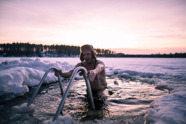 Man climbing into icy water