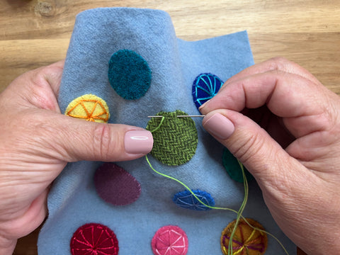 photo of step 2 in wool appliqué eyelet wheel stitch