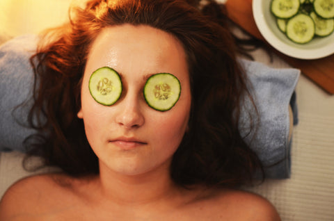 women with cucumbers on her eyes - pearline's apothecary