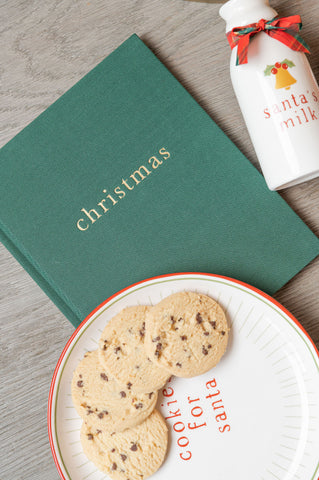 Green linen journal with santa's cookies on plate and milk jug