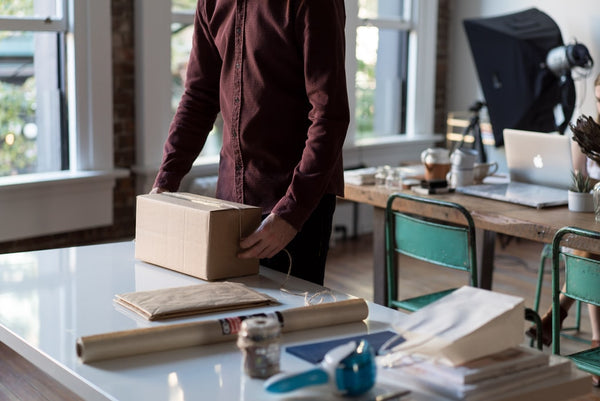 man shipping items in a box