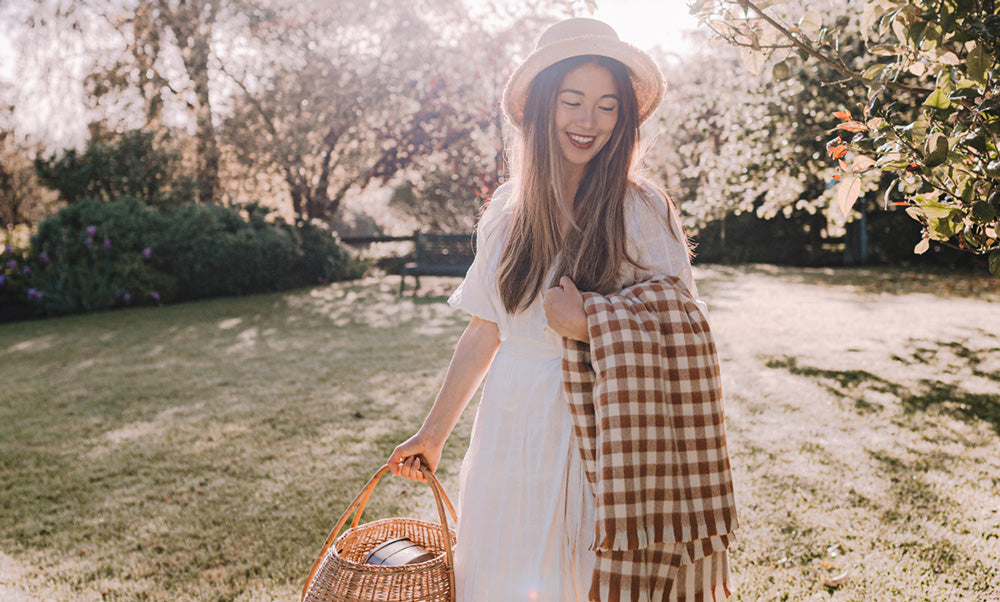 Connie Cao with a picnic basket and merino wool picnic rug.