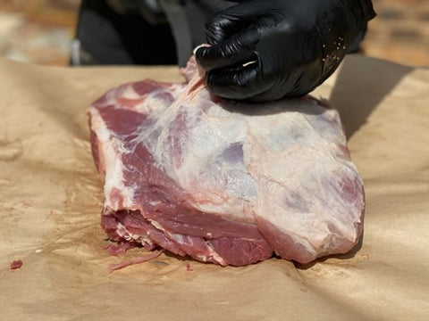 Remove the silverskin from pork shoulder