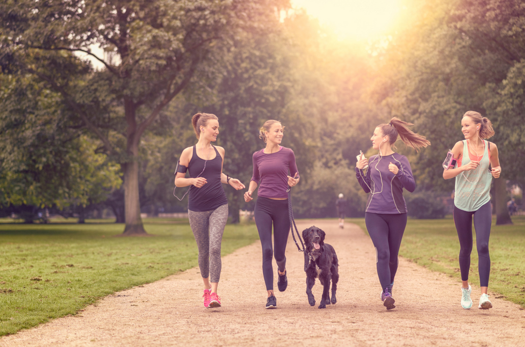 active women jogging with dog