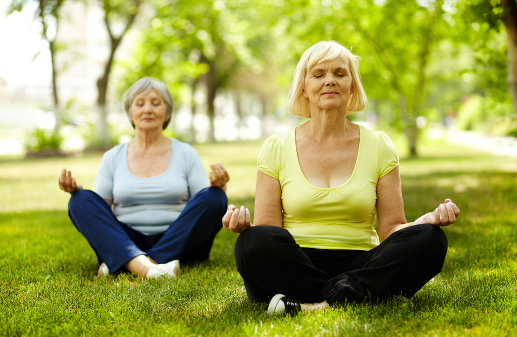 old women doing yoga