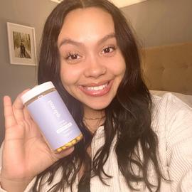 a woman showing the new joint capsule support vitamins