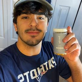 a younger man wearing a hat showing the new joint support capsule vitamin