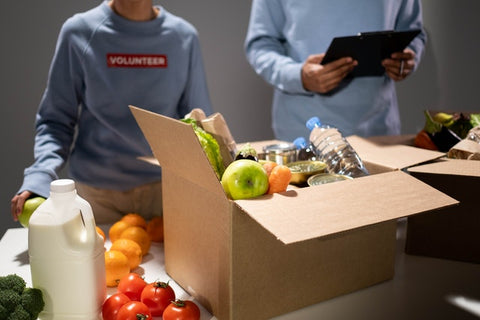 A man and child social entrepreneurs packing supplies for charity.