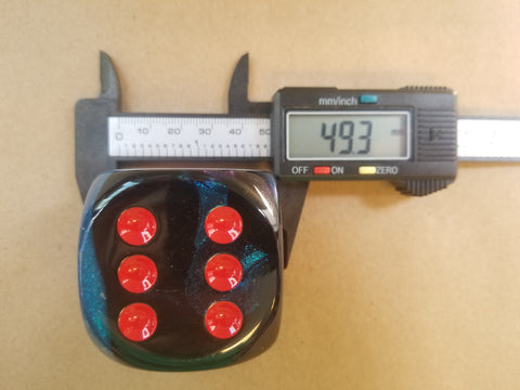 digital caliper with 50mm dice by chessex dice being measured.