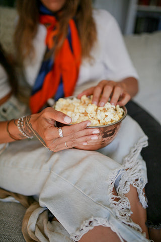 5 Sweet Treats that Make Great Mother’s Day Gifts if Your Mom Has a Sweet Tooth - mom eating popcorn