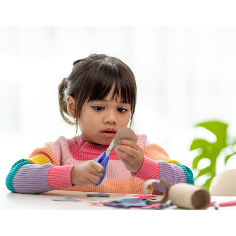 a child concentrating on an art project