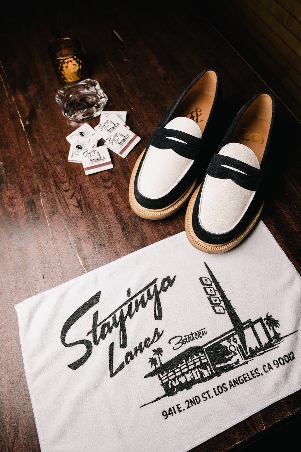 Some shoes and a towel on a table.