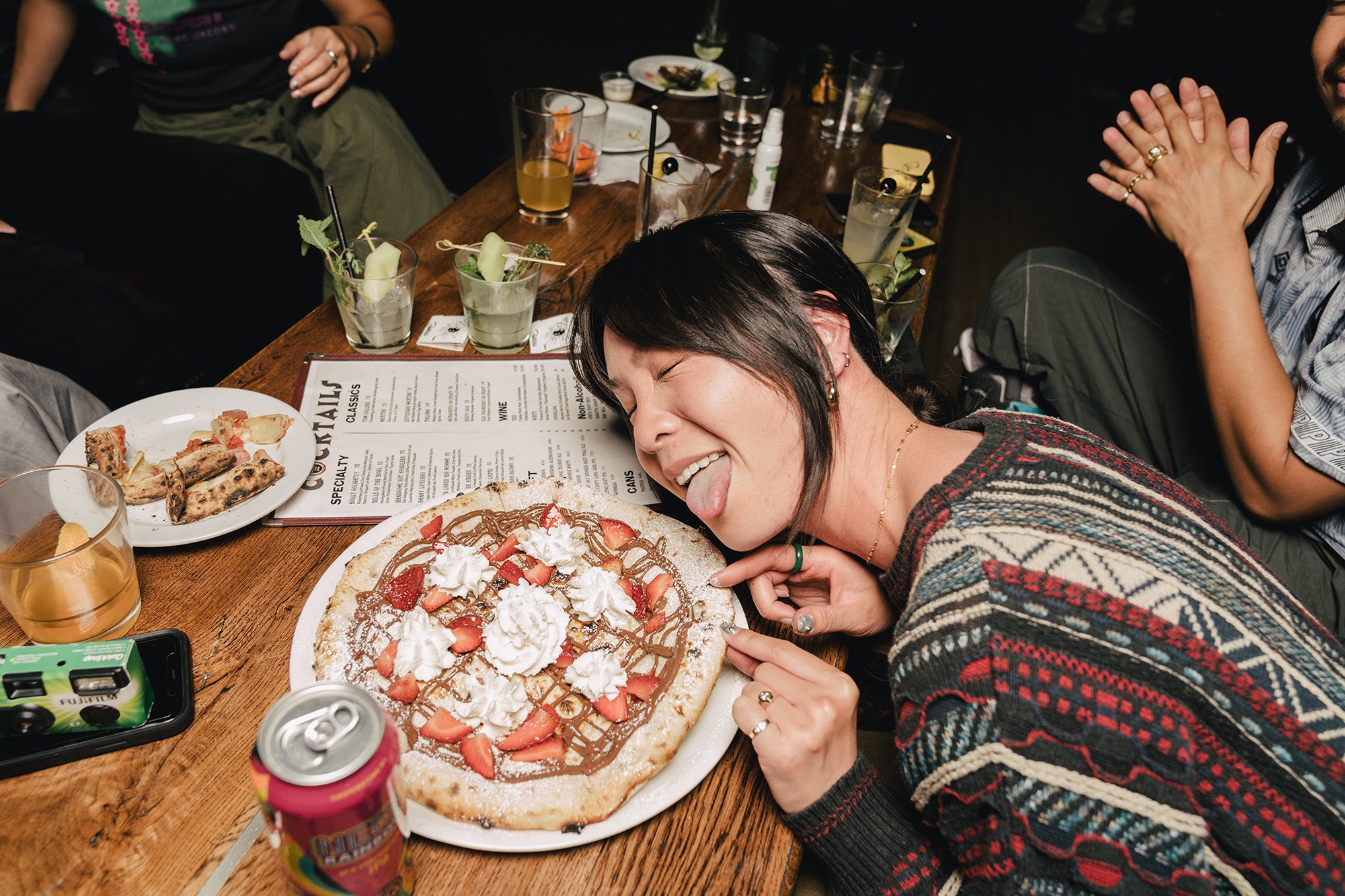 A young lady is excited about her dessert pizza.